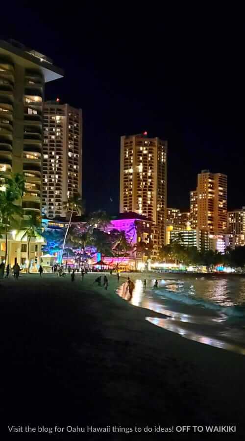 walking waikiki beach at night near moana surfrider